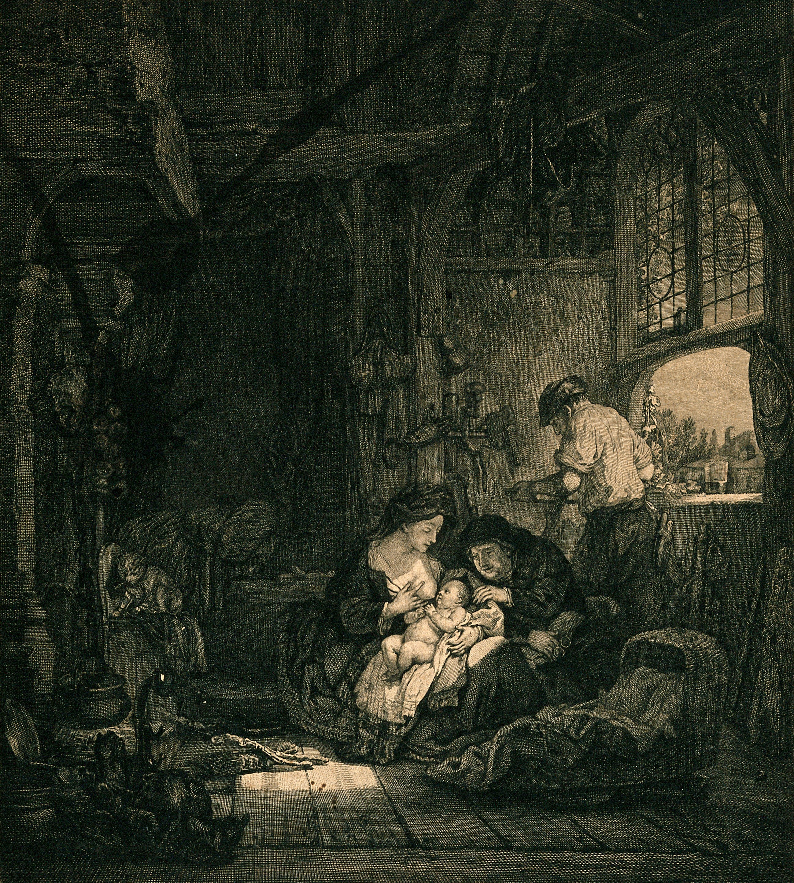 A woman breast feeding her baby in the family's home and workshop